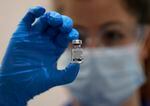 A nurse holds a vial of the Pfizer-BioNTech COVID-19 vaccine at Guy's Hospital in London, Tuesday, Dec. 8, 2020, as the U.K. health authorities rolled out a national mass vaccination program.  U.K. regulators said Wednesday Dec. 9, 2020, that people who have a “significant history’’ of allergic reactions shouldn’t receive the new Pfizer/BioNTech vaccine while they investigate two adverse reactions that occurred on the first day of the country’s mass vaccination program.