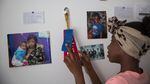 Azaysha looks at ribbons pinned to the wall of her room in Portland, Ore., Wednesday, May 22, 2019. Azaysha's wall includes photos of her family, a drawing a friend made of her, photos of her favorite band, and her first report card with letter grades.