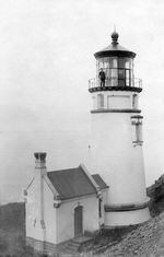 A lightkeeper stands atop the Heceta Head Lighthouse north of Florence, Ore., in an undated historical photo.