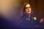 Oregon Gov. Kate Brown speaks to reporters in her ceremonial office at the Capitol in Salem, Ore., Monday, Jan. 14, 2019.