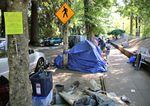 A line of tents on a busy Portland street. Last week, Mayor Ted Wheeler announced a planned crackdown on homeless camps near busy roadways.

