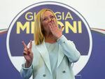 Far-Right party Brothers of Italy's leader Giorgia Meloni flashes the victory sign at her party's electoral headquarters in Rome, early Monday, Sept. 26, 2022.