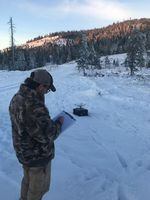 Lead researcher James Goerz checks out the drone before it takes off to photograph moose cows and calves.