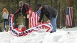 Pacific Patriots Network co-founder B.J. Soper, right, helps rebuild the roadside memorial to deceased militant LaVoy Finicum.