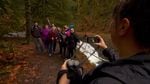Jenny Bruso snaps a photo during an Unlikely Hikers group hike at Silver Falls State Park.