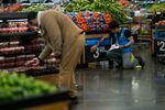 A worker places a price for vegetables inside the Walmart Supercenter in North Bergen, Thursday, Feb. 9, 2023, in New Jersey.