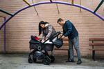 Tatyana Polishchuk and her husband Volodymyr Polishchuk tend to their baby Ania at a playground outside their apartment in Kyiv.
