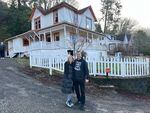 Behman and Liz Zakeri are pictured in January 2023, in front of their new home in Astoria, which was used in the filming of the 1985 cult classic "The Goonies."