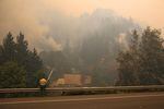 An officer looks on as fire crews work to keep the Eagle Creek Fire away from the Multnomah Falls Lodge Tuesday, Sept. 5, 2017. 