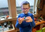 Oli Weith, 7, plays at his home in Southeast Portland on Dec. 29, 2022. Oli has autism spectrum disorder and is a second grader at Buckman Elementary, where his parents say he does not receive adequate support.