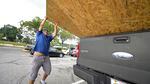 Jesus Rodrigues loads wood into his vehicle Monday outside a Home Depot store in Orlando, Fla., in preparation for the arrival of Hurricane Ian.