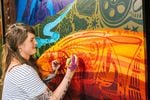 Liza Burns paints her mural, "Celebrate Oregon!"
