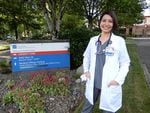 Dr. Genoveva O’Neill, a family medicine doctor, stands in front of a sign for PeaceHealth Family Medicine of Southwest Washington in Vancouver. Here she cares for patients of all ages.