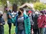 Katya Samodurov of the Oregon & SW Washington chapter of the Alzheimer’s Association holds an Alzheimer's flag as she leads a walk through Alberta Park in Northeast Portland during a dementia-friendly walk, Nov. 10, 2021. 
