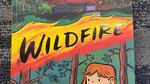 A book cover that two nervous-looking young girls in the woods holding a cat. The word "Wildfire" is emblazoned above their heads.