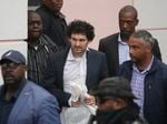 FTX founder Sam Bankman-Fried, center, is escorted from the Magistrate Court in Nassau, Bahamas, Wednesday, Dec. 21, after agreeing to be extradited to the U.S.