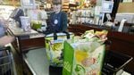 Zupan's Markets clerk Katie Miller bags a customer's groceries in reusable bags. Like other Portland grocery stores, plastic bags are banned here.