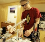 Zeke Wheeler, 13, demonstrates one of the tabletop satellite antennas he's working with in Portland, Oregon on Sept. 30, 2024.