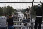 People watch from an overpass as protesters marching against racist violence and police brutality block traffic on Interstate 84 in Portland, Ore., on June 8, 2020.