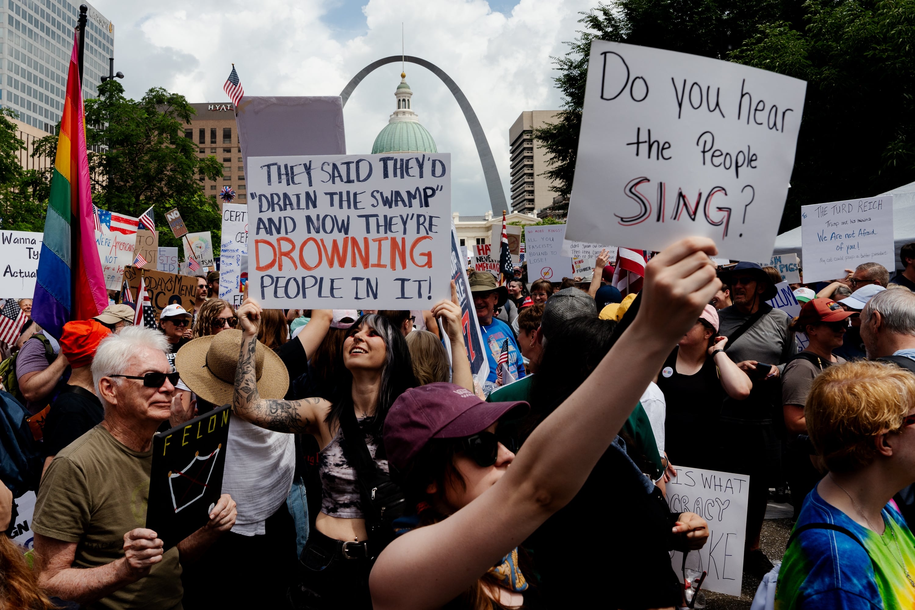 St. Louis: Robert Hull, a 76-year-old demonstrator from St. Charles, left in green, protests alongside his granddaughter Maddie Flynn, 29 of Wentzville, center, during the No Kings protest, in downtown St. Louis.