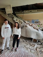 Vova Hrabovenko, 17, and his teacher Viktoria Timoshenko in what's left of her biology classroom after Russian shelling. "I didn't recognize it at first," she says.