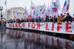 FILE - People participating in the March for Life walk past the Supreme Court, Jan. 19, 2024, in Washington.