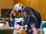 Rep. Christine Drazan, left, R-Canby, talks with Rep. Shelly Boshart Davis, R-Albany, on the House Chamber floor at the Oregon State Capitol, May 18, 2021 in Salem, Ore.