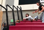 Graduating senior Malakai Stephens, left, passes a rose into the bleachers during a ceremony at Perrydale High School on June 6, 2026 in Amity, Ore. Perrydale is one of 19 Oregon school districts with a 100% graduation rate in 2025.