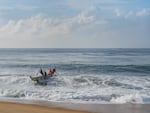 A boat returns to shore in Ivory Coast.