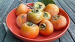 A bowl of persimmons.