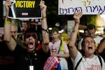 Holding signs with photos of Israeli hostages and demanding their release, people react as they watch Prime Minister Benjamin Netanyahu's speech before the U.S. Congress, Wednesday, July 24, 2024, in Tel Aviv, Israel.