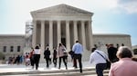 People walk into the U.S. Supreme Court in Washington, D.C., on Tuesday, the day that the court's majority rejected the once-fringe idea that state legislatures' power over congressional elections cannot be checked or balanced by state constitutions or state courts.