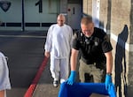 Jesse Lee Johnson, 62, center, walks free from Marion County Jail custody in Salem, Sept. 5, 2023, just hours after prosecutors agreed to dismiss his case. Johnson spent 25 years in police and prison custody, including more than a decade on death row, for an Oregon murder he has consistently denied committing.