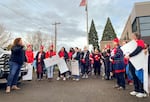 FILE: Union President Tyler Scialo-Lakeberg, left, speaks to members and supporters of the Salem-Keizer Education Association at a rally outside the district's administrative offices in Salem, Ore., on Dec. 19, 2023. The teachers union reached a tentative deal with the district to avert a strike early Tuesday morning.