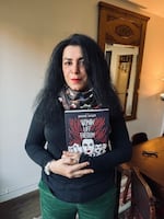 Marjane Satrapi, a graphic novelist, holds her latest book Woman, Life, Freedom, in her home in Paris, France.