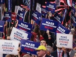 Attendees at the Republican National Convention hold up signs reading "Mass Deportation Now!" last month in Milwaukee.