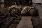 Ukrainian soldiers take cover from incoming artillery fire in Irpin, the outskirts of Kyiv, Ukraine, Sunday, March 13, 2022.