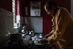 Shahu Patole prepares food in his mothers kitchen in Khamgaon, India on November 11, 2024. Maya Levin for NPR