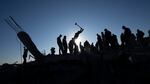 Palestinians search for bodies and survivors in the rubble of a house destroyed in an Israeli airstrike, in Rafah, southern Gaza Strip, on Sunday.