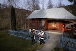 Volodymyr Sinitovych, director of the Hutsul Theater, greets his son and grandchild outside the small museum in Krasnoillya where the history of Hutsul theater is documented and sometimes performed.