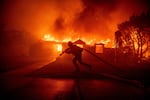 Tuesday, Jan. 7: A firefighter battles the Palisades Fire.