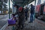 Woman checking her cat during evacuation procedures from Pokrovsk.