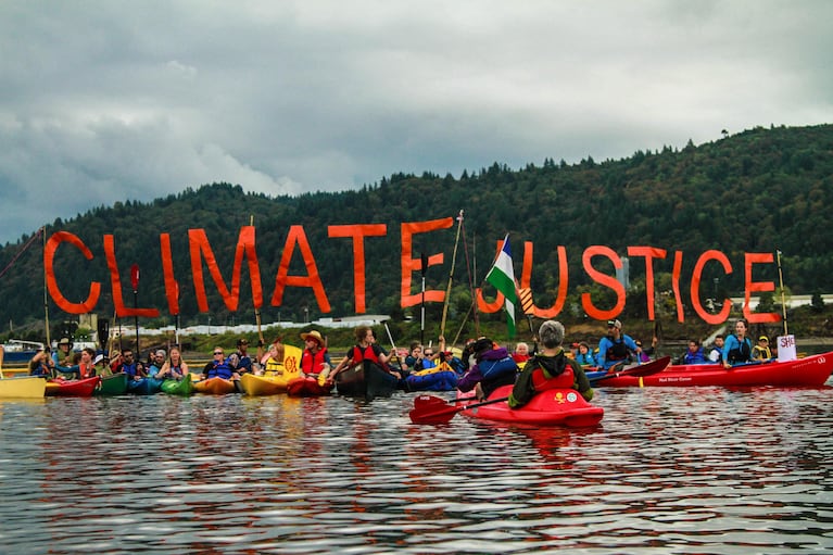 The kayakers coordinated their sign display in a few different locations near the vessel.