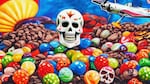 A sugar skull on a pile of candy.