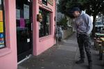 A man reads a sign in the window of North Portland taqueria ¿Por Qué No? announcing their temporary closure on March 16, 2020, in Portland, Ore. That evening a state mandated bar and restaurant closure went into effect.