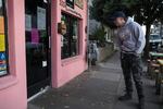 A  man reads a sign in the window of North Portland taqueria ¿Por Qué No? announcing their temporary closure on March 16, 2020, in Portland, Ore. That evening a state mandated bar and restaurant closure went into effect.