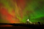 The aurora borealis is seen in an incredible display in the skies above the causeway leading to Holy Island in Northumberland, England, in the early hours or Friday morning.