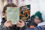 A patron reads a book they chose from the Street Books library in February.