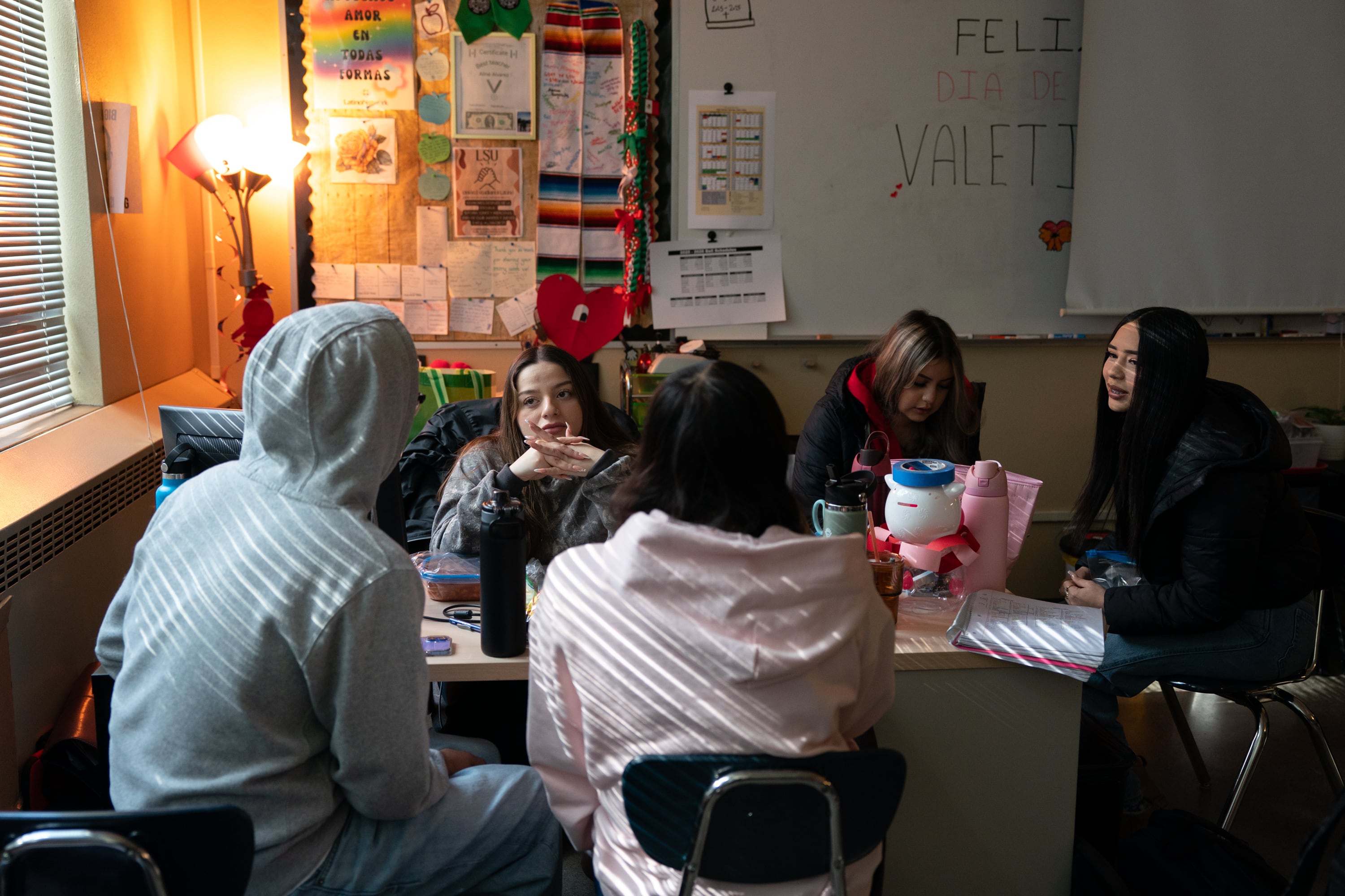 Aline Alvarez Garcia talks with Latino Student Union students including LSU president Valeria, far right, in her classroom during lunch at David Douglas High School in Portland, Ore., on Feb. 20, 2026.