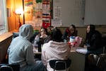 Aline Alvarez Garcia talks with Latino Student Union students including LSU president Valeria, far right, in her classroom during lunch at David Douglas High School in Portland, Ore., on Feb. 20, 2026.